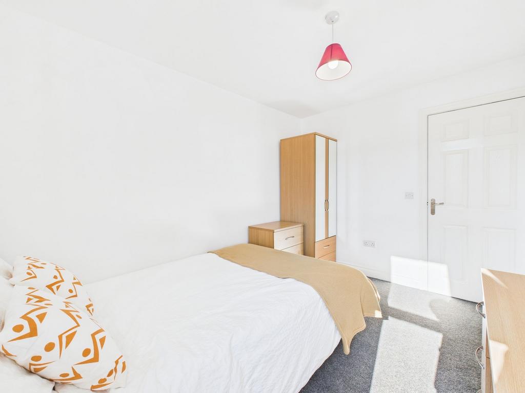Bright and inviting double bedroom with natural...