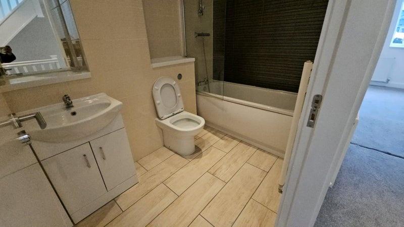 A clean and modern bathroom suite featuring a b...