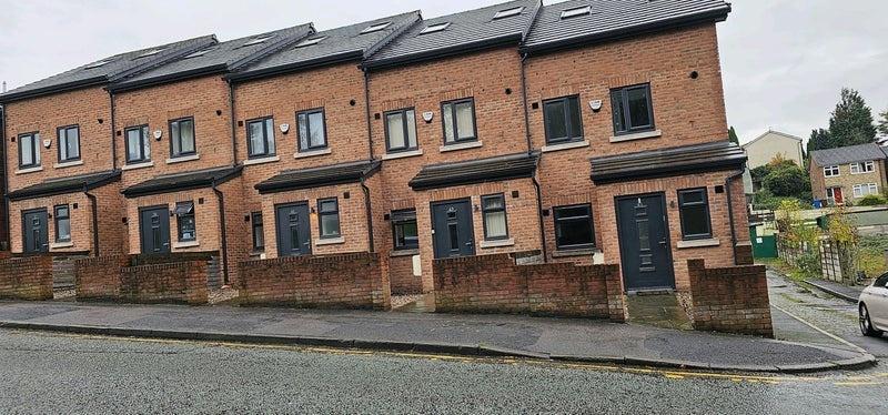 Row of modern terraced brick houses with neat f...