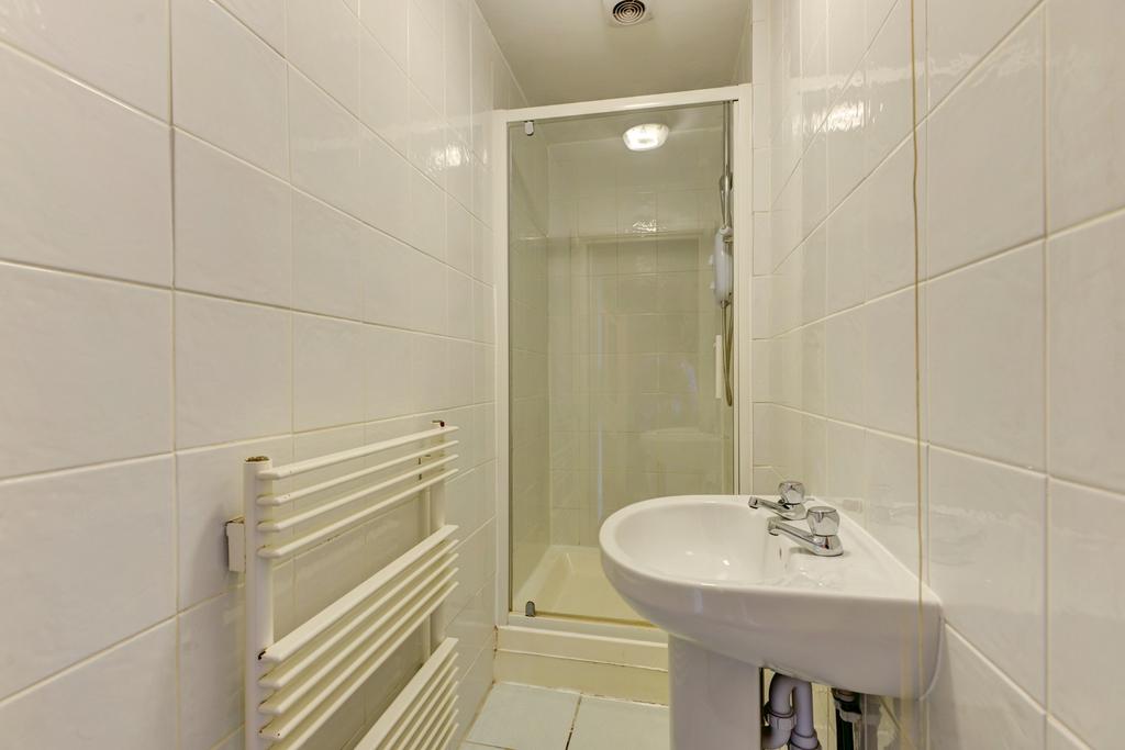 Bright, clean bathroom with a walk-in shower, w...
