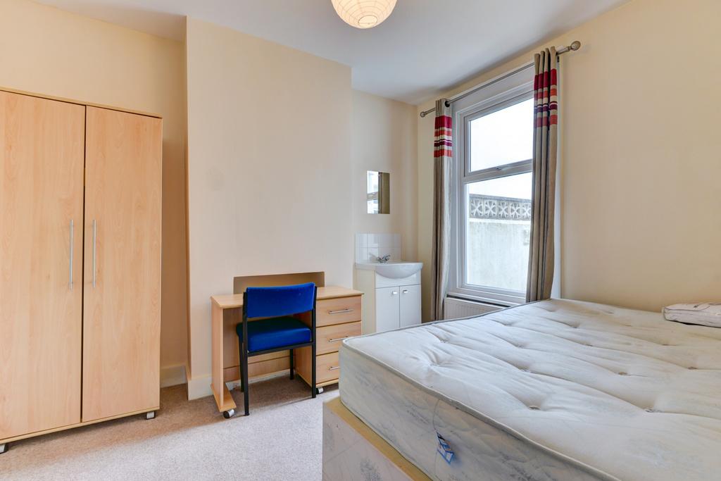 A clean and bright bedroom featuring a large wi...
