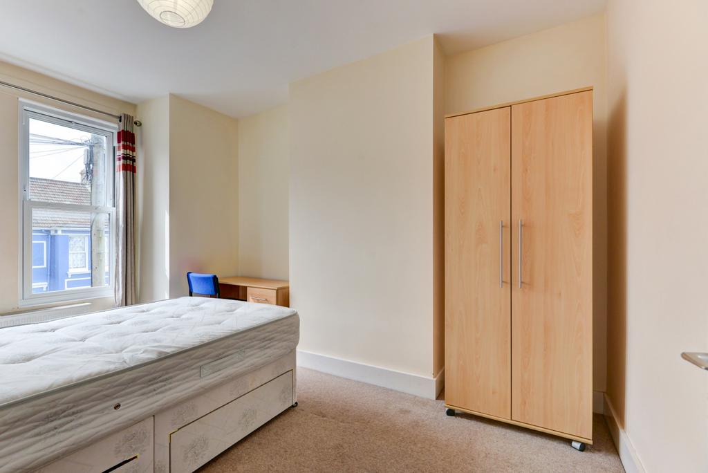 A tidy and well-maintained bedroom with a comfo...
