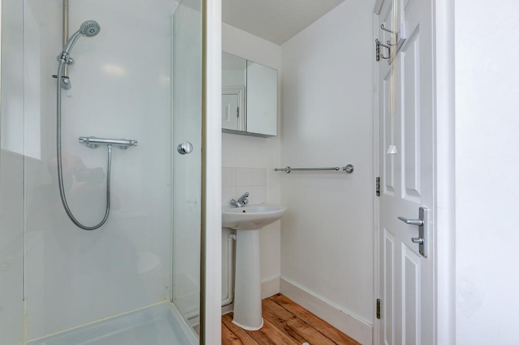 Bright, modern bathroom featuring a walk-in sho...