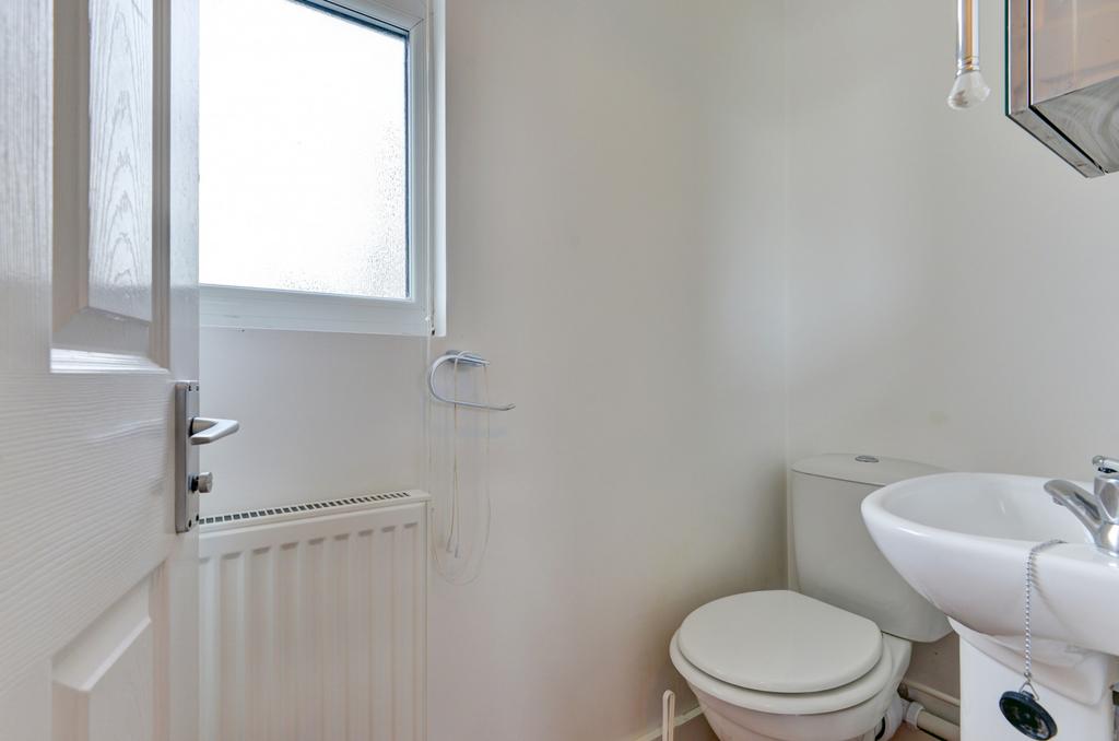 Bright, well-kept bathroom with a clean white t...