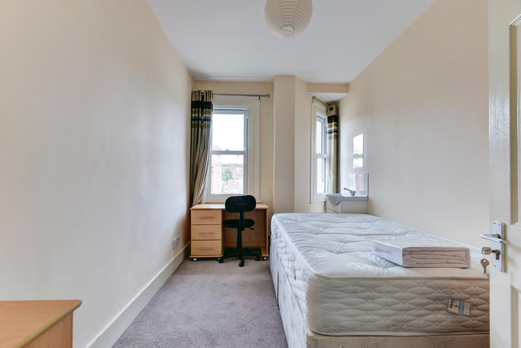 Bright, simply furnished single bedroom with a ...