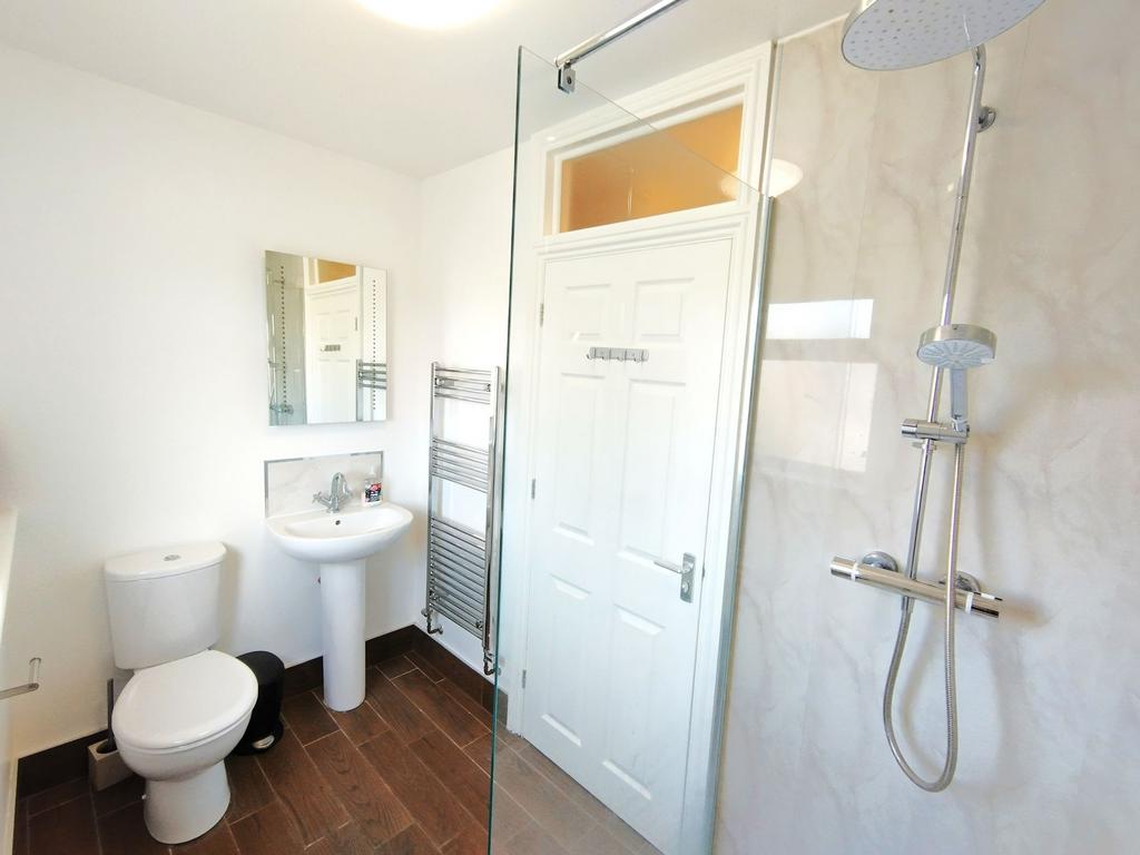 Bright, modern bathroom with a walk-in shower, ...