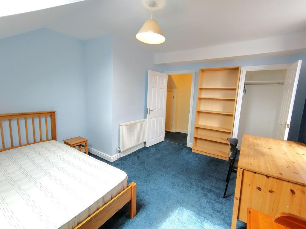 Bright, freshly painted double bedroom with blu...