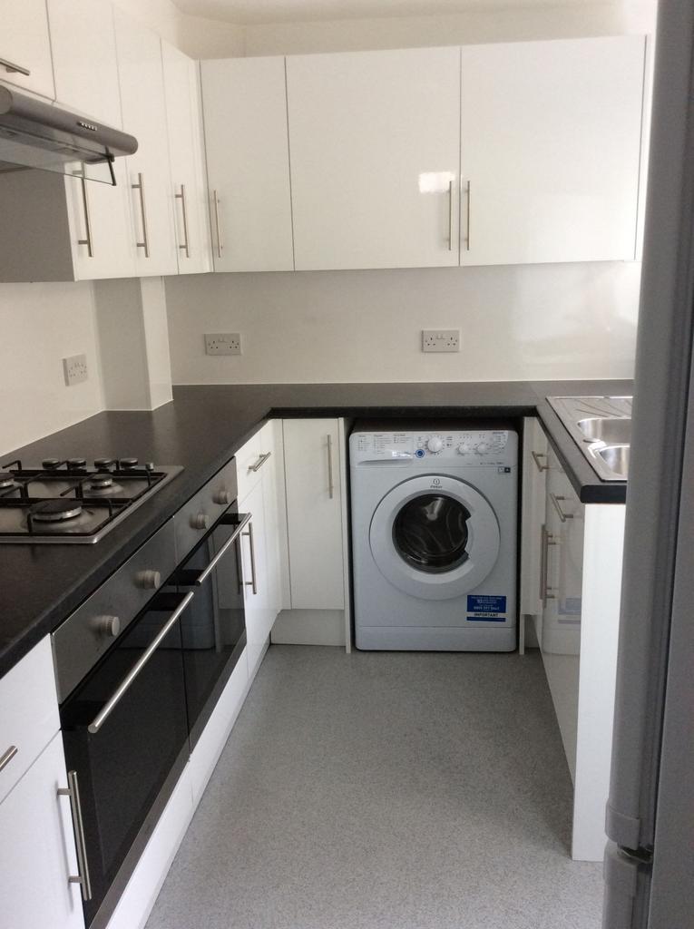 A modern, well-maintained kitchen featuring whi...