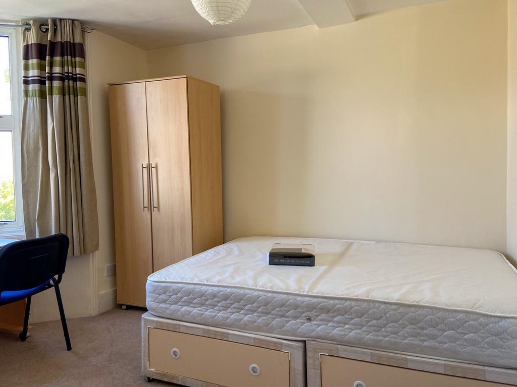 Bright, neatly presented bedroom with twin matt...