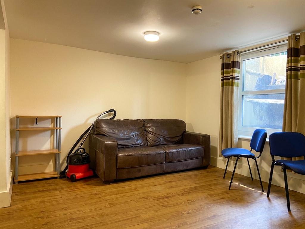 Well-lit communal living area with a comfortabl...