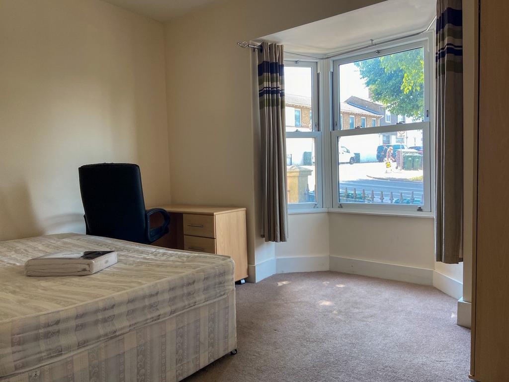 Bright and welcoming double bedroom featuring a...
