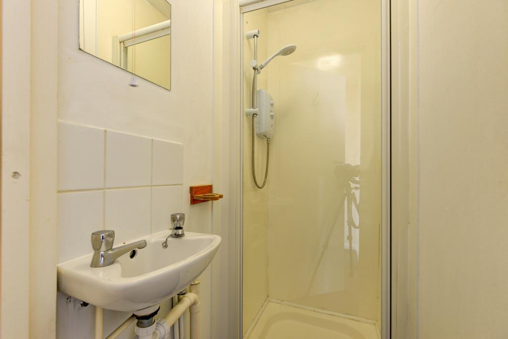 A clean, well-maintained bathroom with a shower...