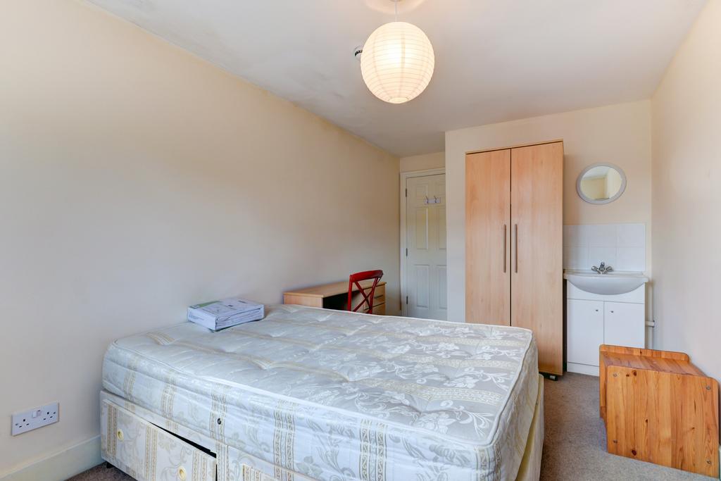 A well-lit, spacious room featuring a large dou...