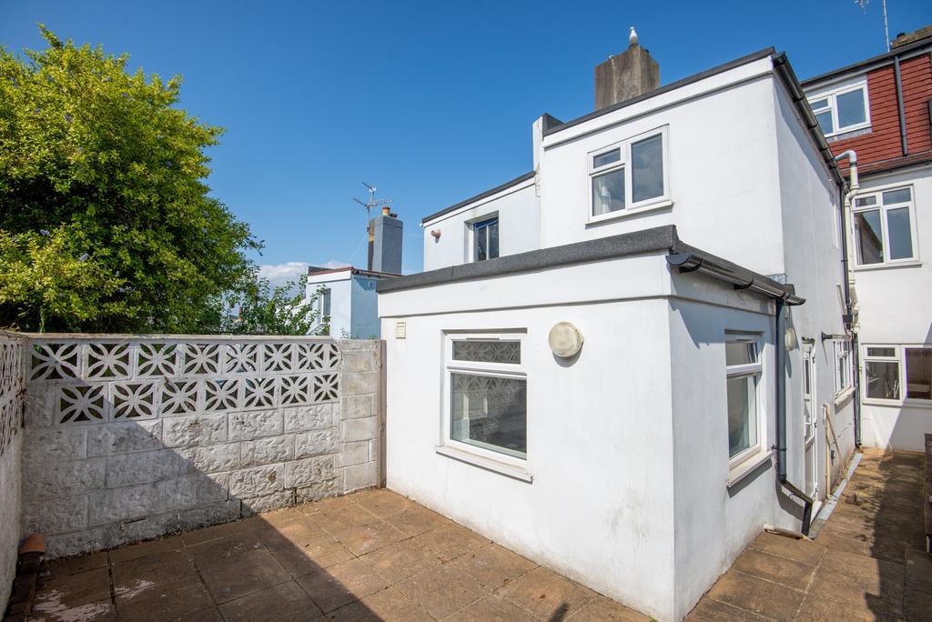Bright and inviting exterior view of a white re...
