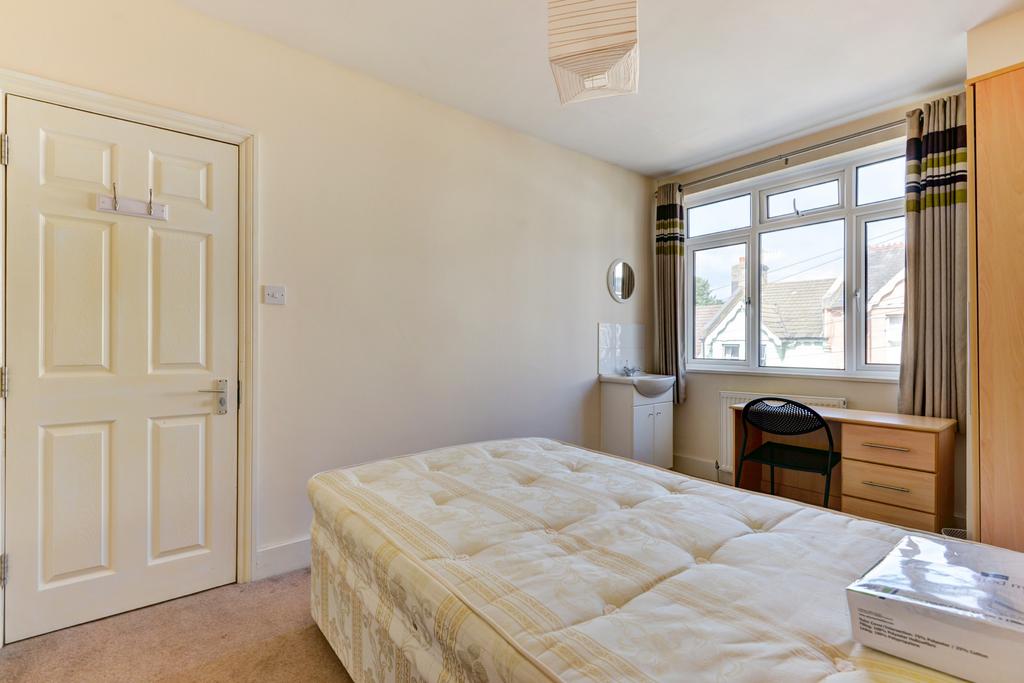 Bright, neutrally decorated double bedroom with...