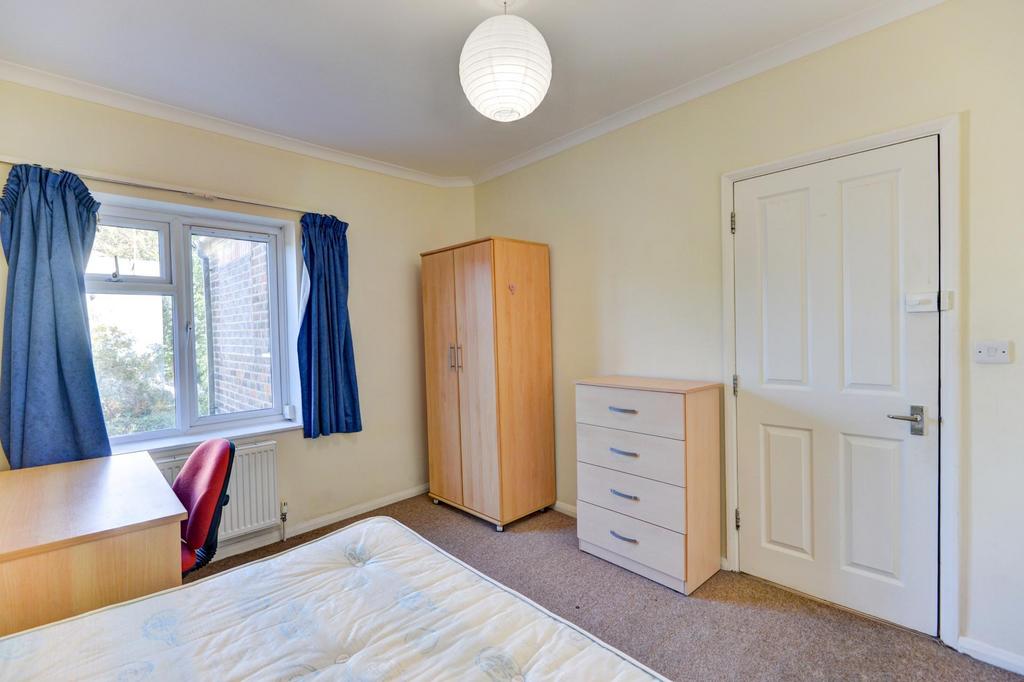 A well-lit double bedroom featuring a window wi...