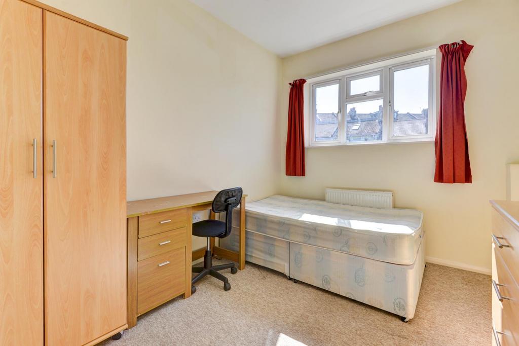 Bright, neatly presented bedroom with a large w...