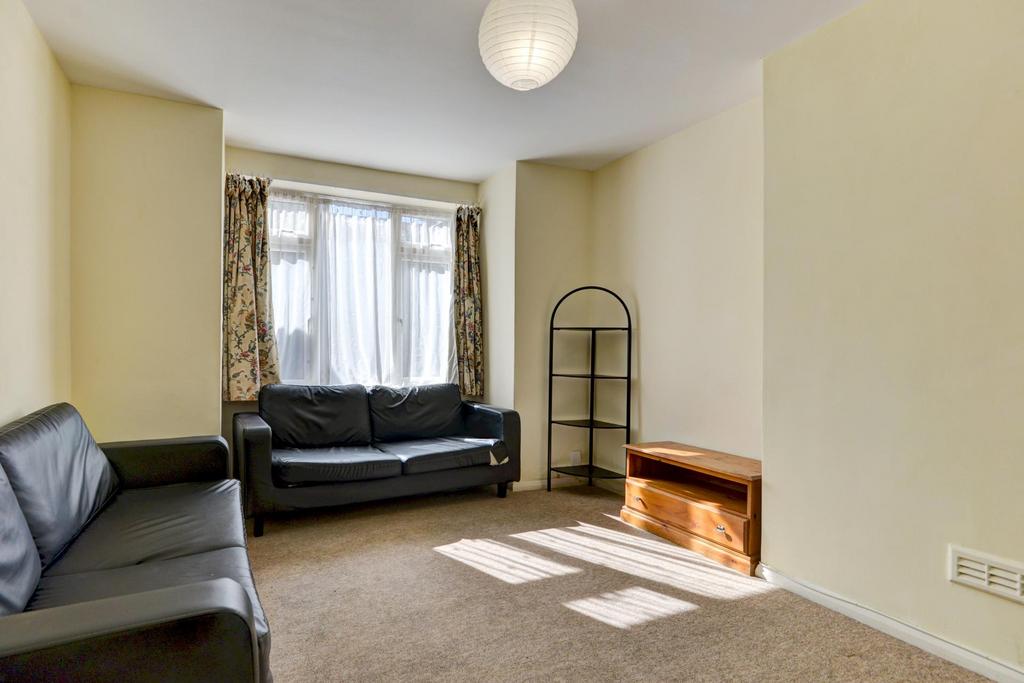 Bright, simply furnished living room with two s...
