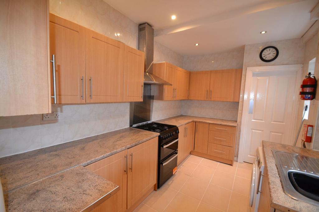 Modern kitchen with ample wooden cabinetry, gra...