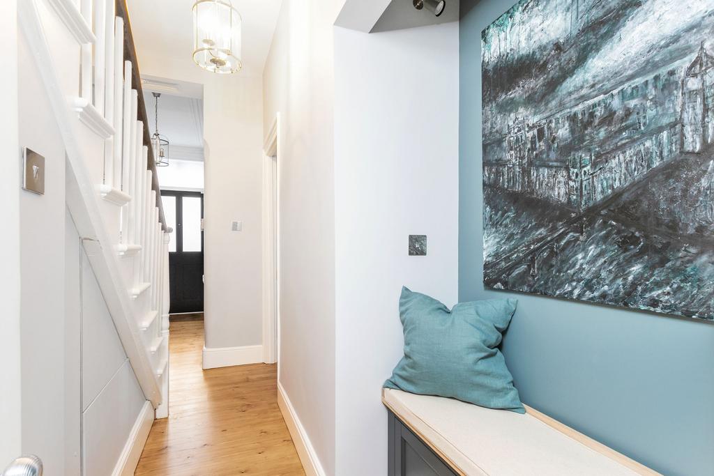Hallway with illuminated nook and under stair...