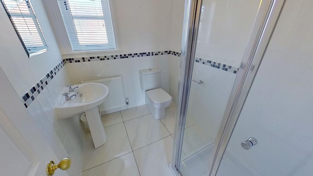 Bright, modern bathroom with a tiled floor, ped...