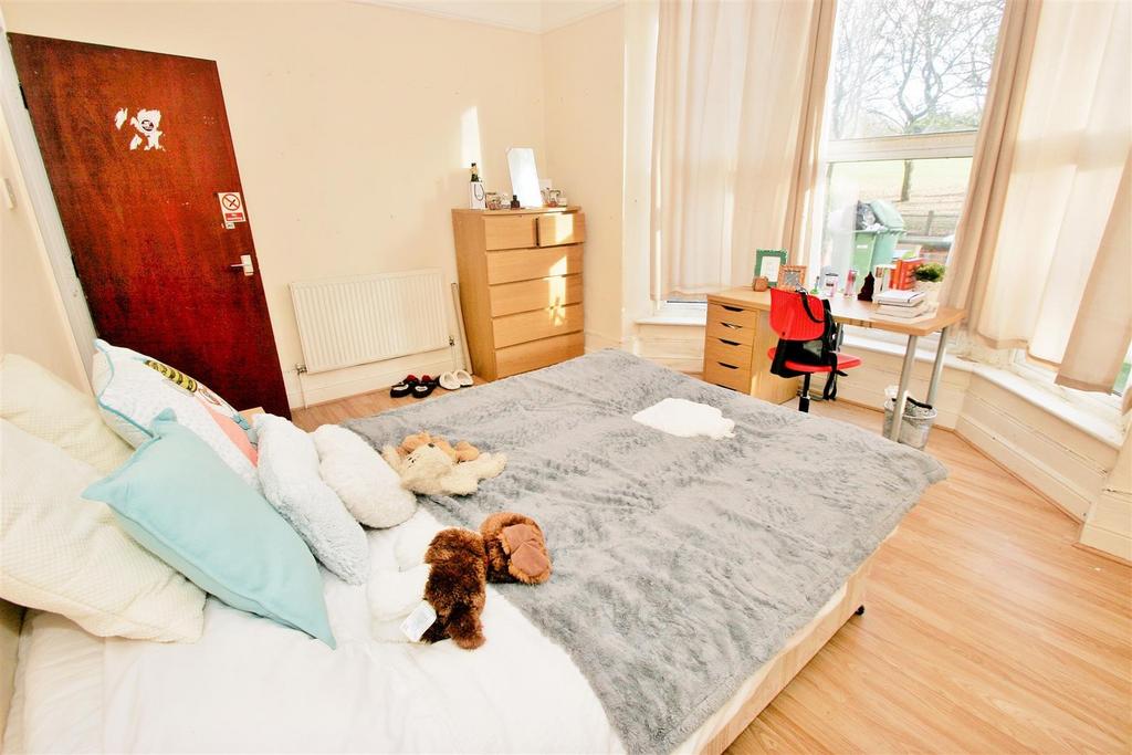 Bright and welcoming double bedroom featuring a...