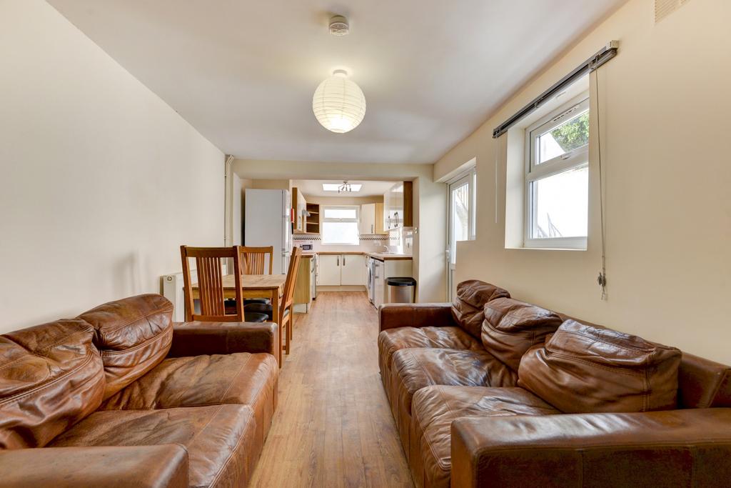 A bright and welcoming living room with ample s...