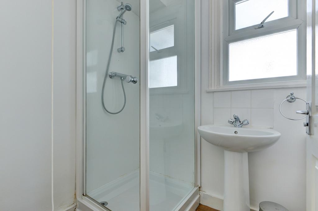 Bright, well-maintained bathroom with a clear g...