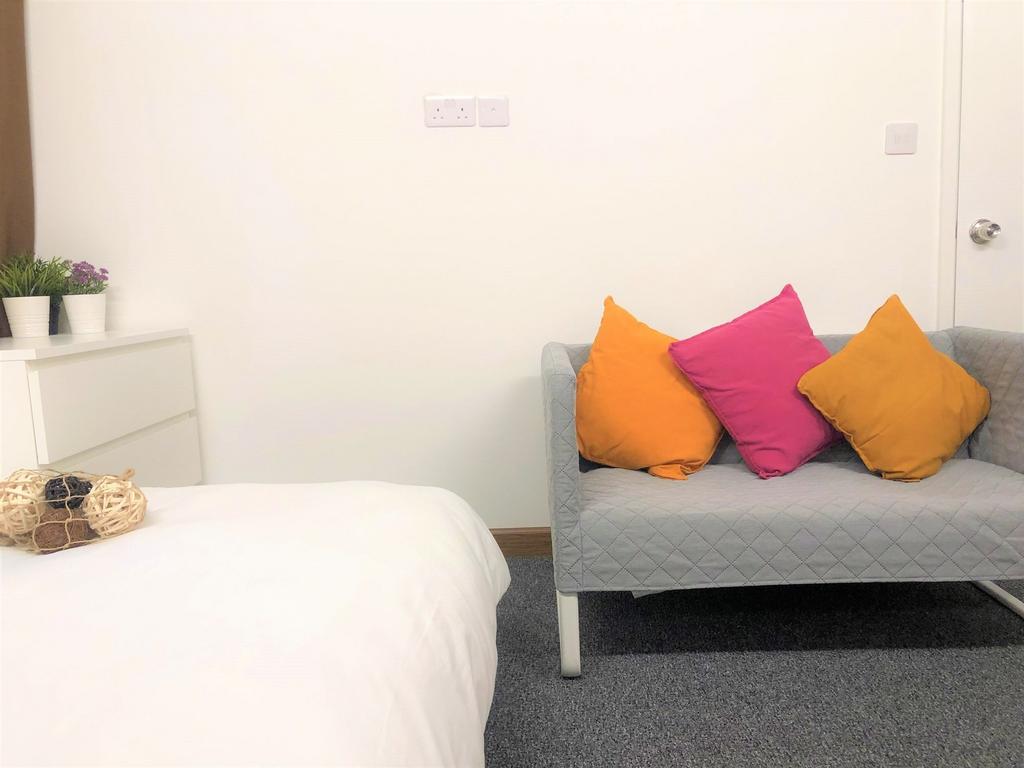 Bright and tidy double bedroom featuring a comf...