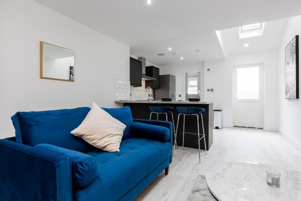A bright and modern living room featuring a vib...