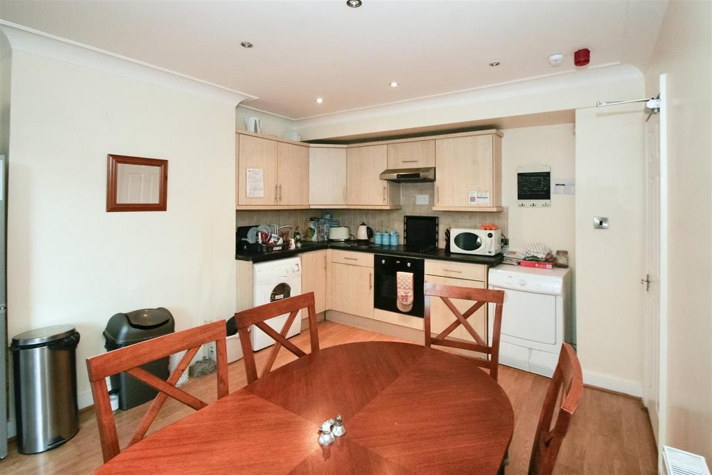 A compact but functional kitchen featuring ligh...