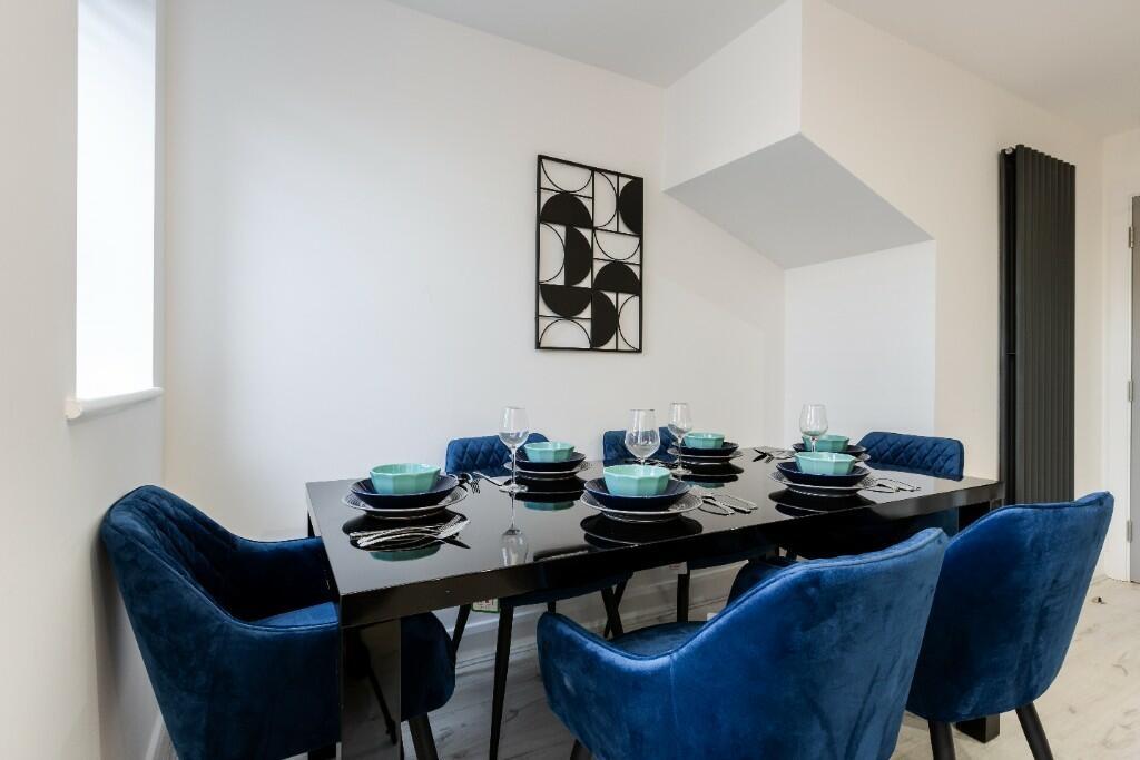 A stylish and modern dining area featuring a sl...