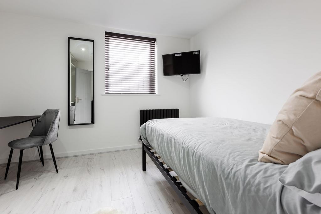 A bright and modern double bedroom featuring a ...