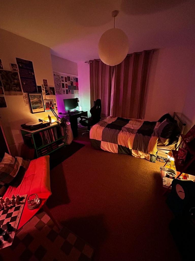 Warm, cozy bedroom with a comfortable single be...
