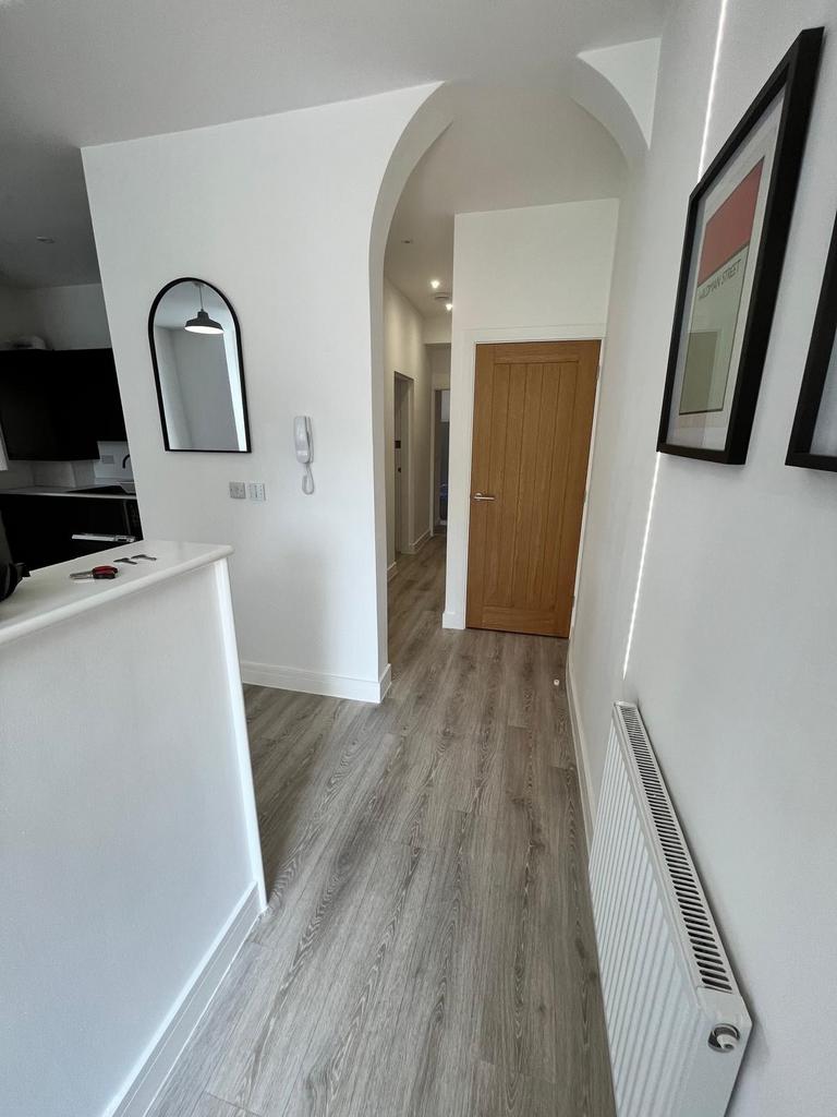 Bright modern hallway with light wood-effect fl...
