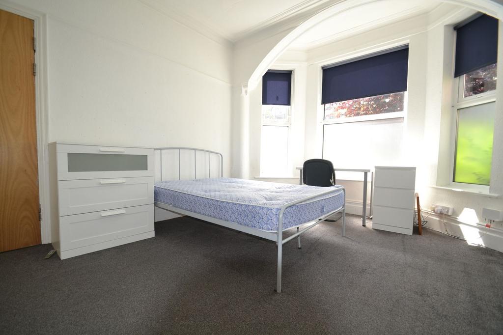 Bright and welcoming double bedroom featuring a...