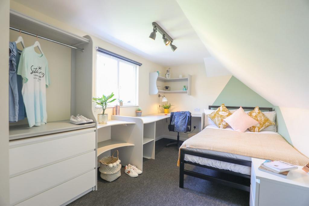 Bright and well-maintained bedroom featuring a ...