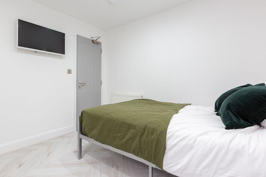 A clean and minimalist bedroom featuring a doub...