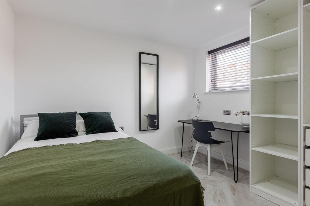 A modern, neatly maintained bedroom with a fres...