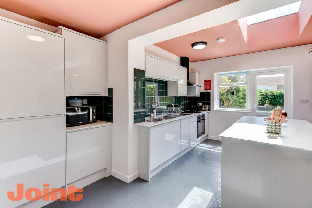 Bright modern kitchen with glossy white cabinet...
