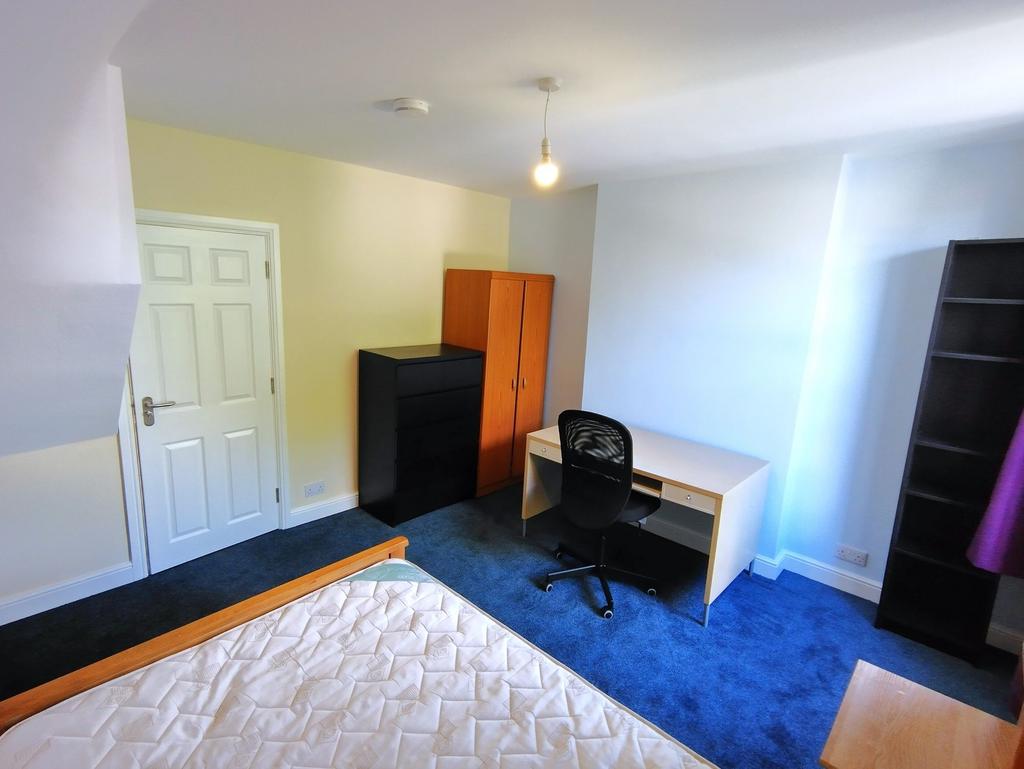 Bright, well-presented bedroom with a study des...