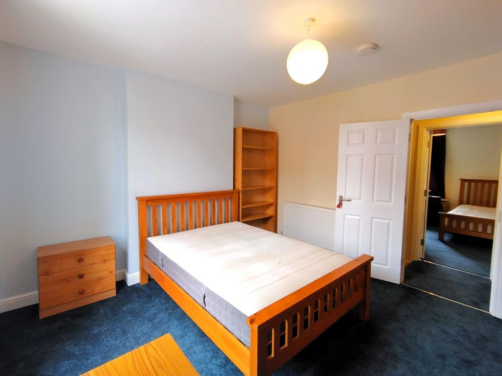 Bright, neat double bedroom with a wooden bed f...