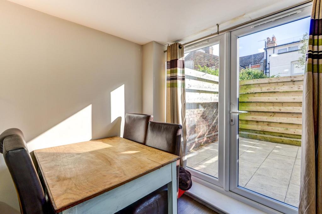 Bright eat-in kitchen area with a dining table ...