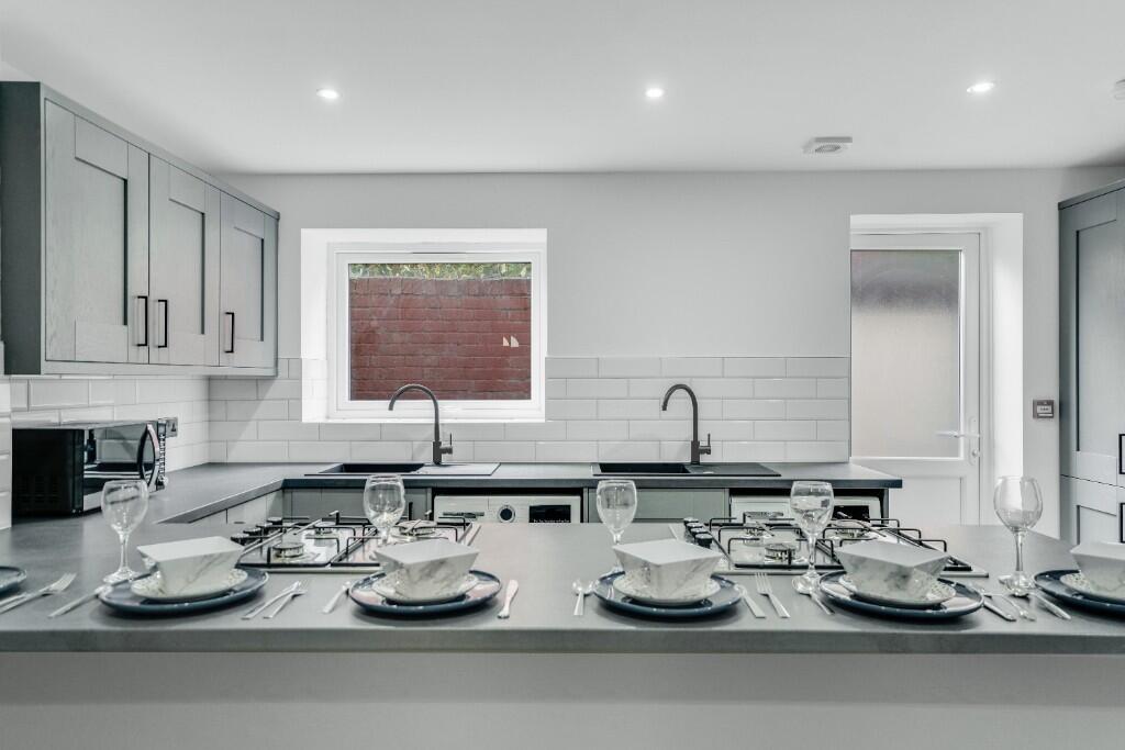Modern kitchen with ample workspace and sleek c...