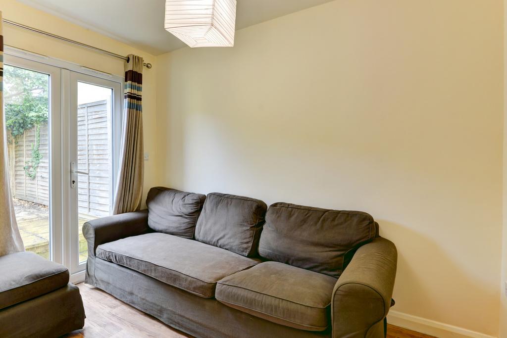 A bright and welcoming living room featuring a ...