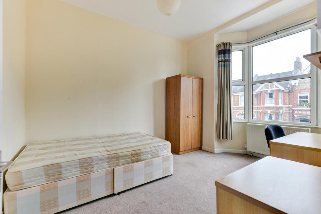 Bright double bedroom with a large bay window b...