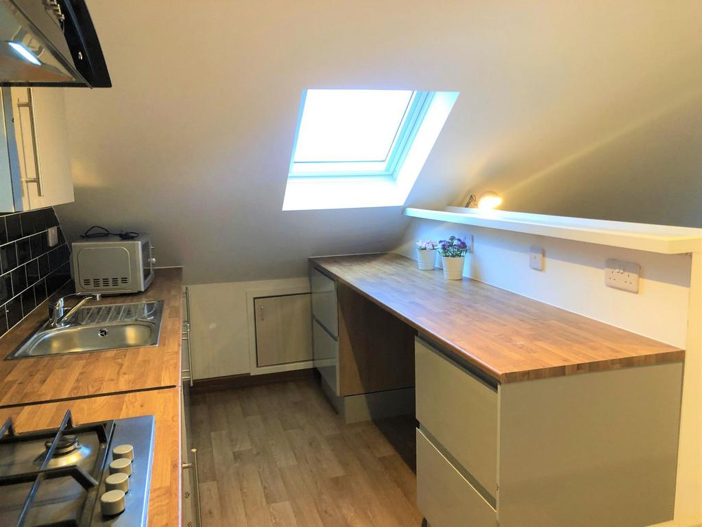 A bright and tidy kitchen featuring modern wood...