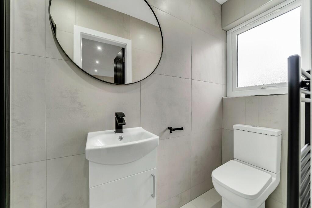 Modern bathroom featuring a large window provid...