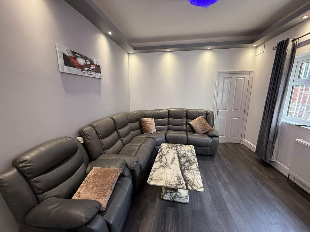 Bright, modern living room with a large L-shape...