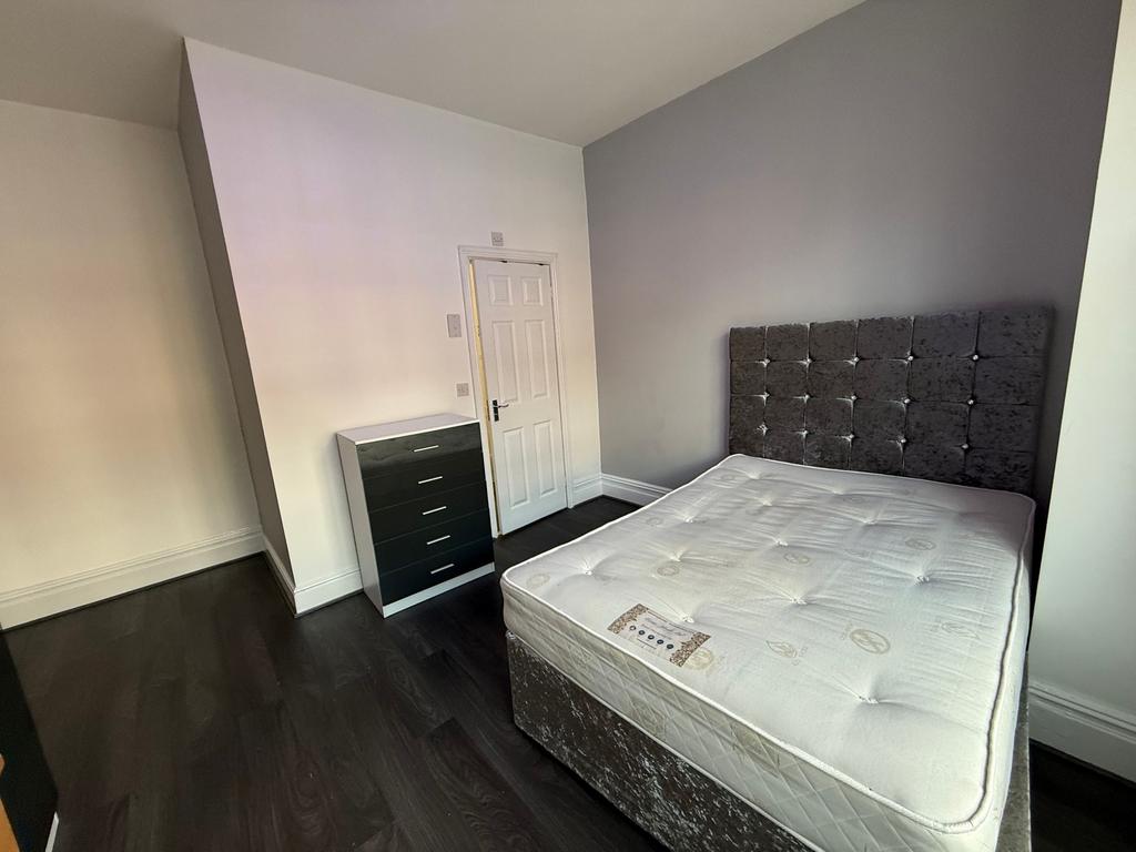 Bright, modern double bedroom with a plush upho...